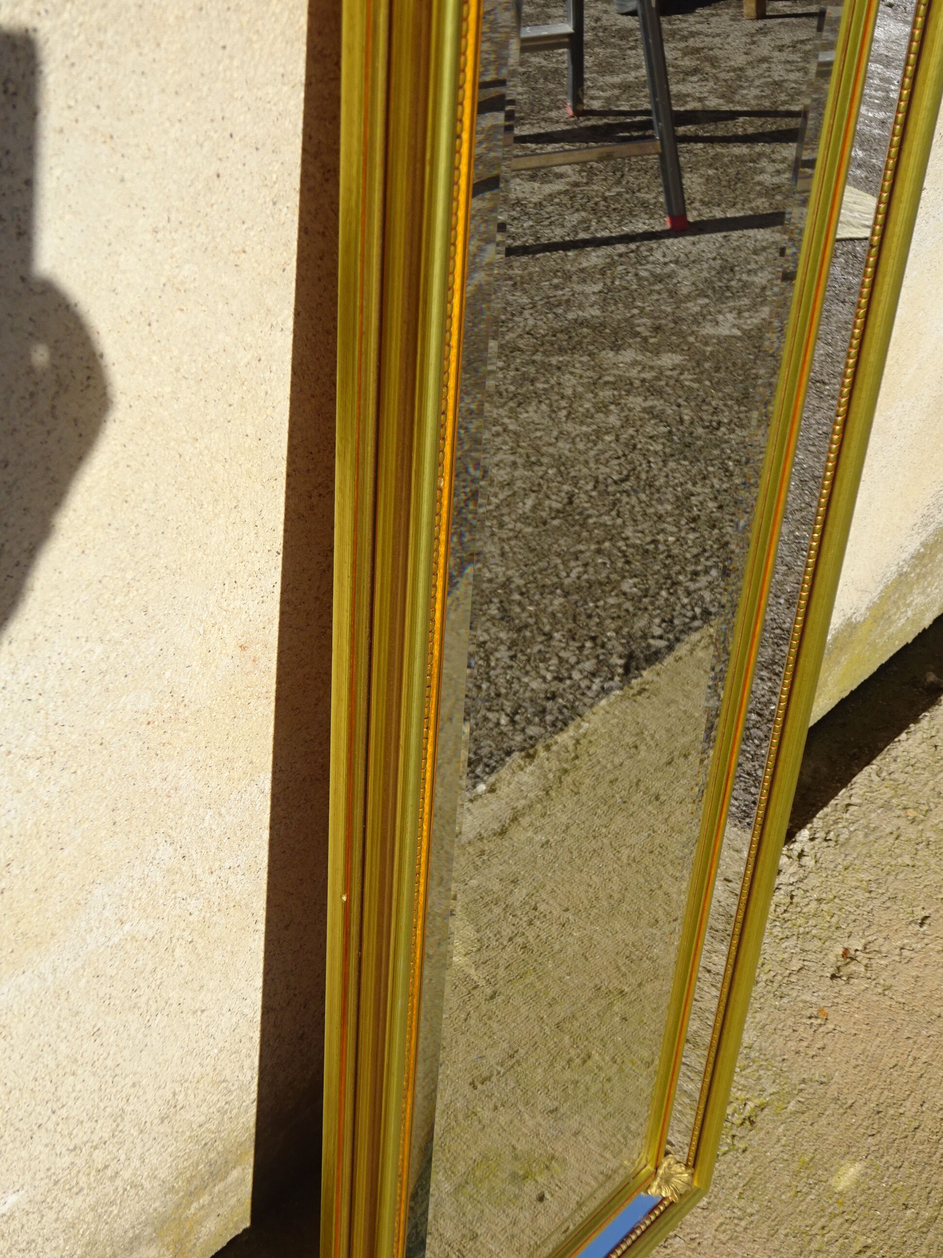 Vertical mirror, gold frame with beading.