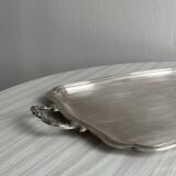 Silver metal serving tray with sculpted handles