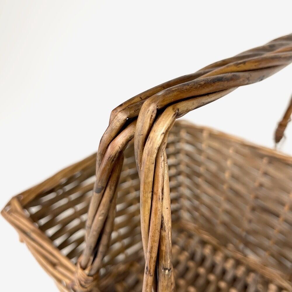 Old basket made of woven wood splices and braided wicker