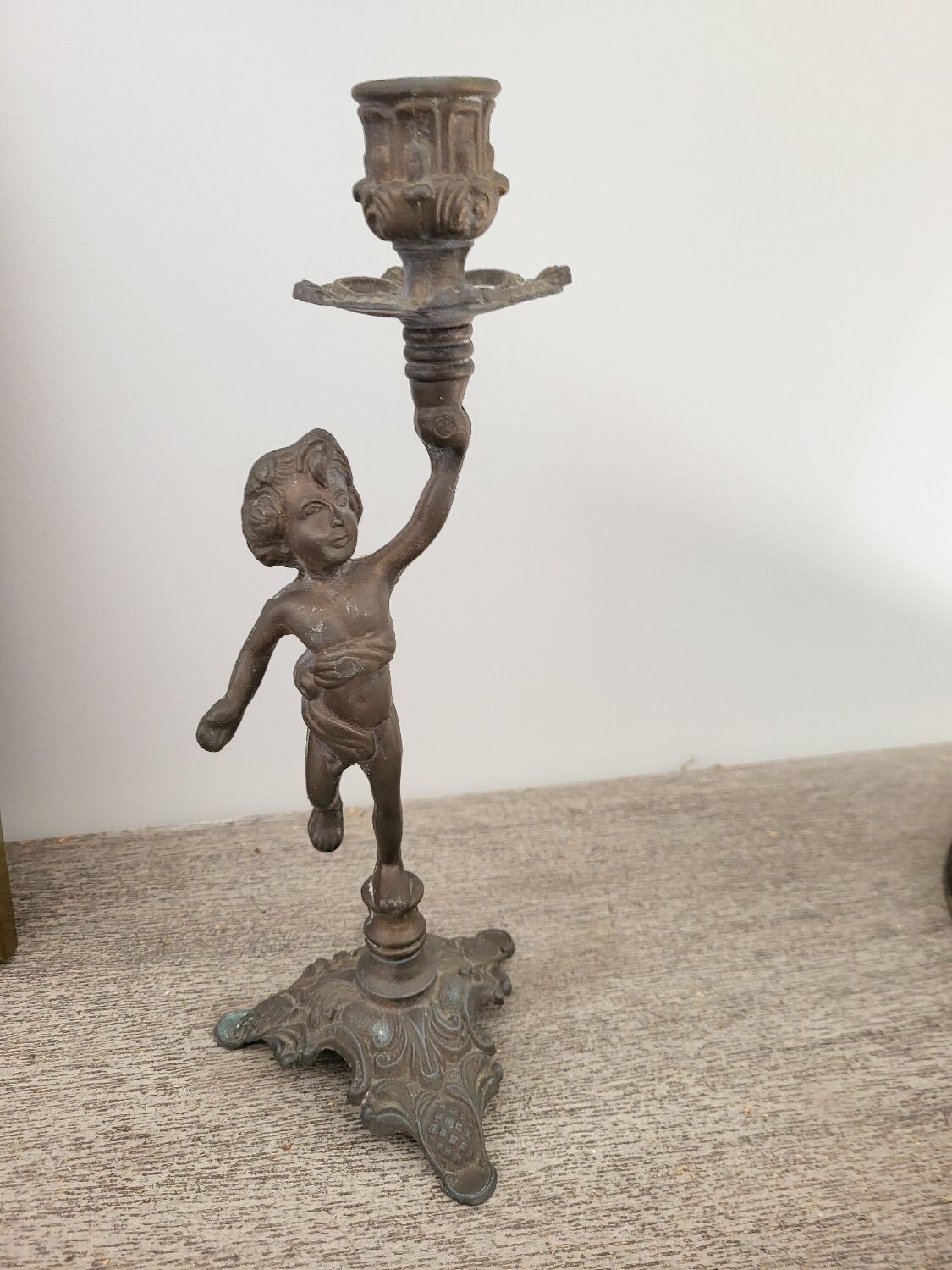 Pewter gray cherub candle holder.