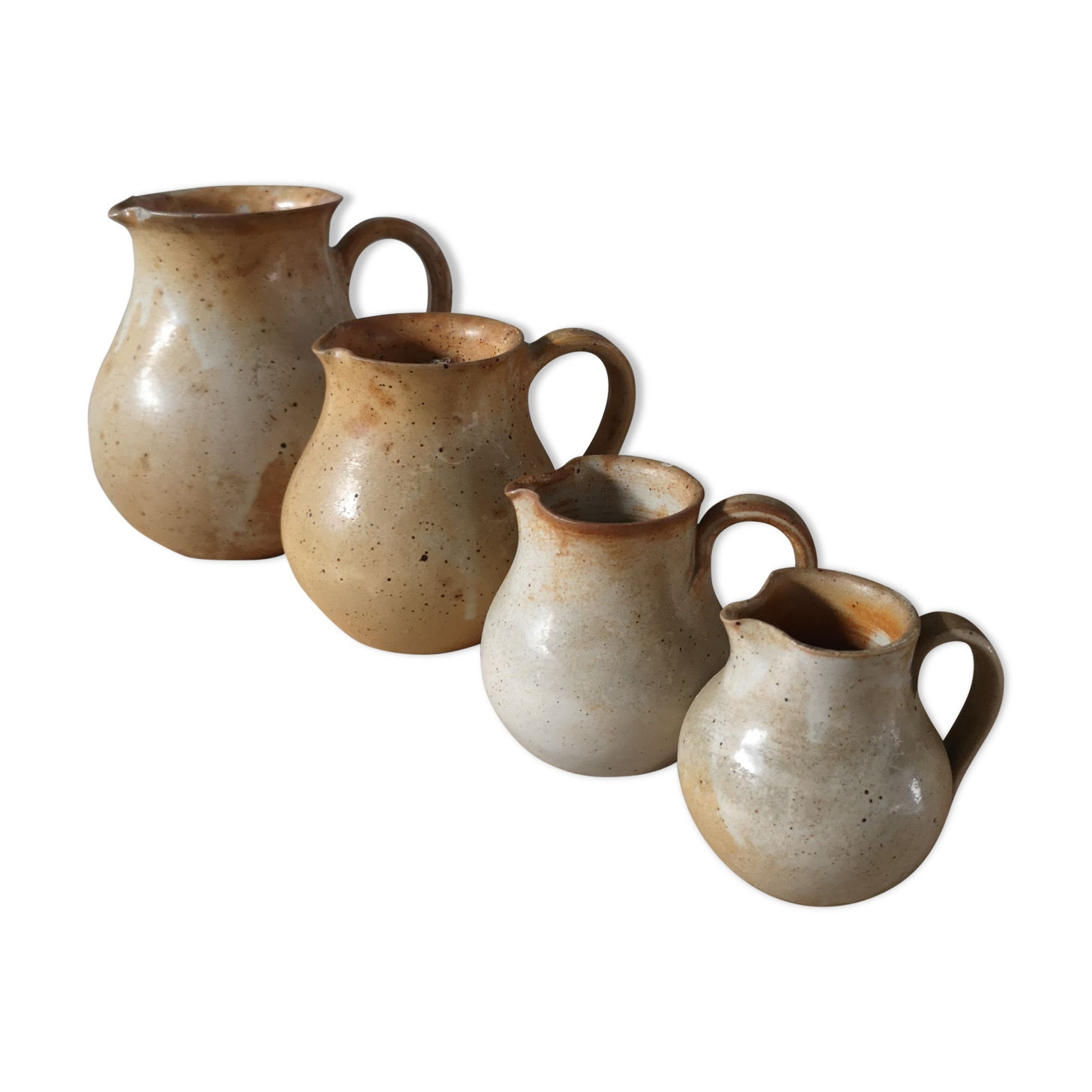 Lot of 4 pitchers in sandstone