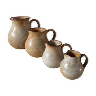 Lot of 4 pitchers in sandstone