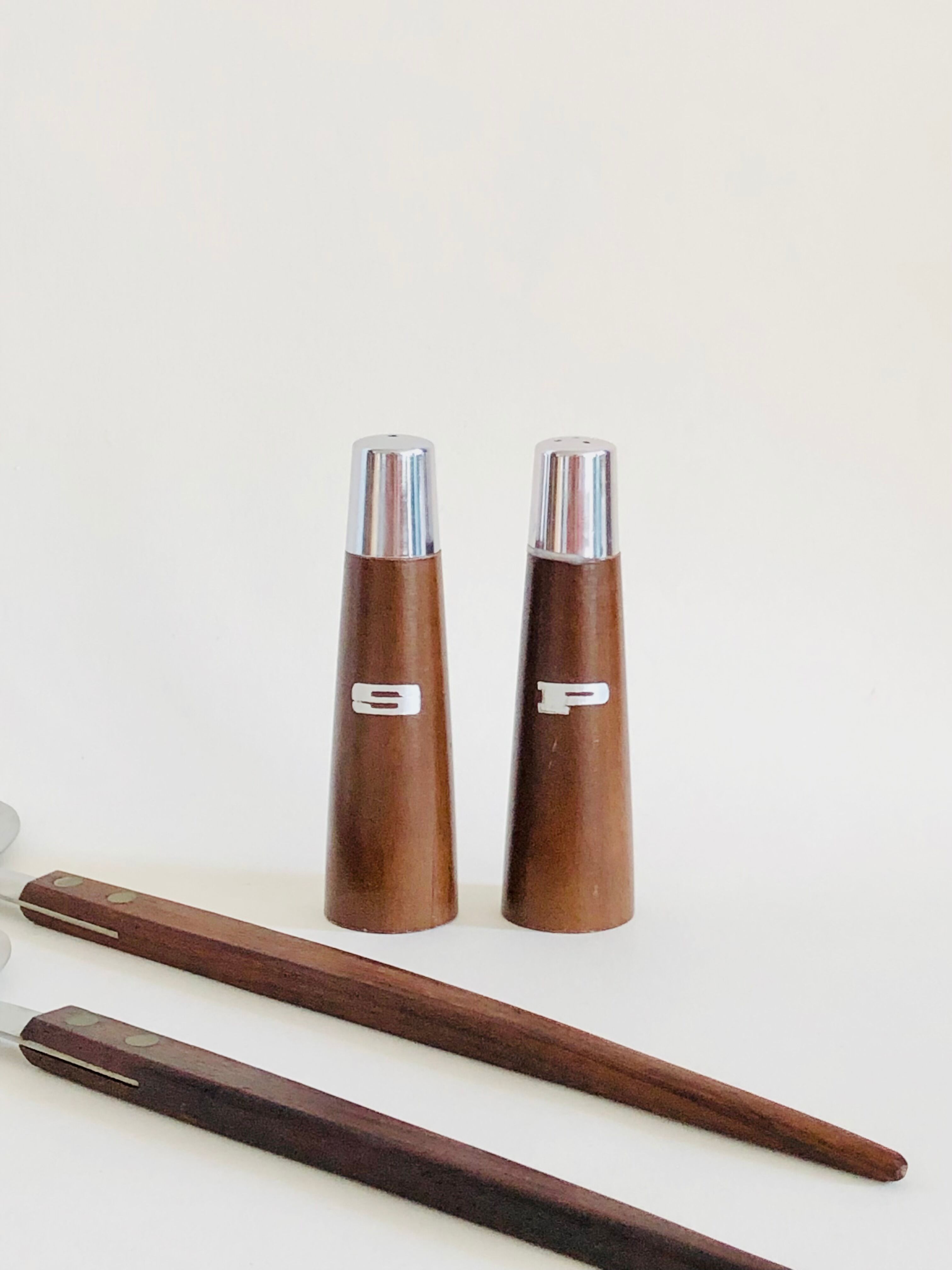 Set of Scandinavian salad cutlery, salt and pepper shaker in teak and steel