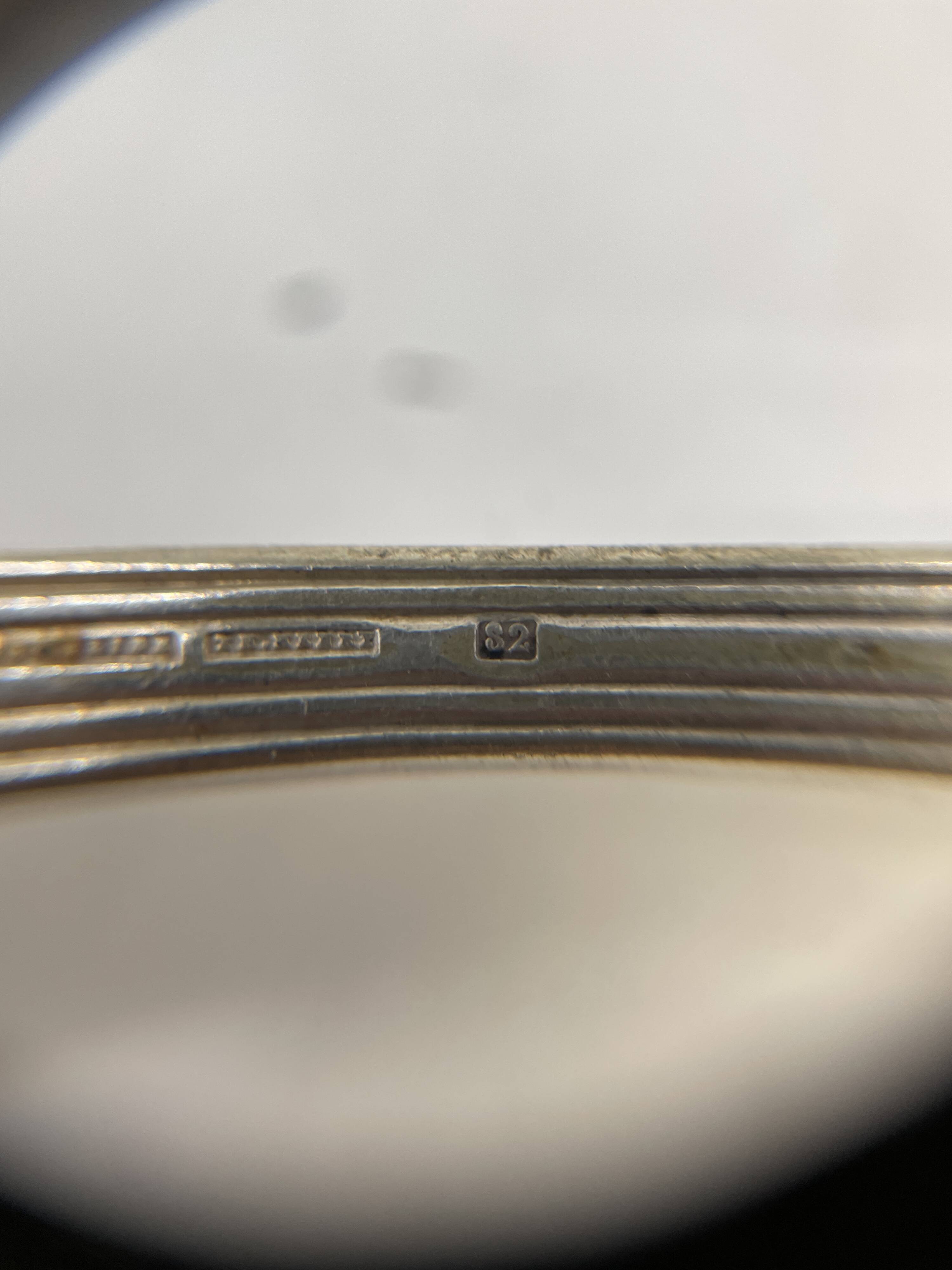Set of 7 silver-plated dessert spoons with a bi-lobed filet pattern.