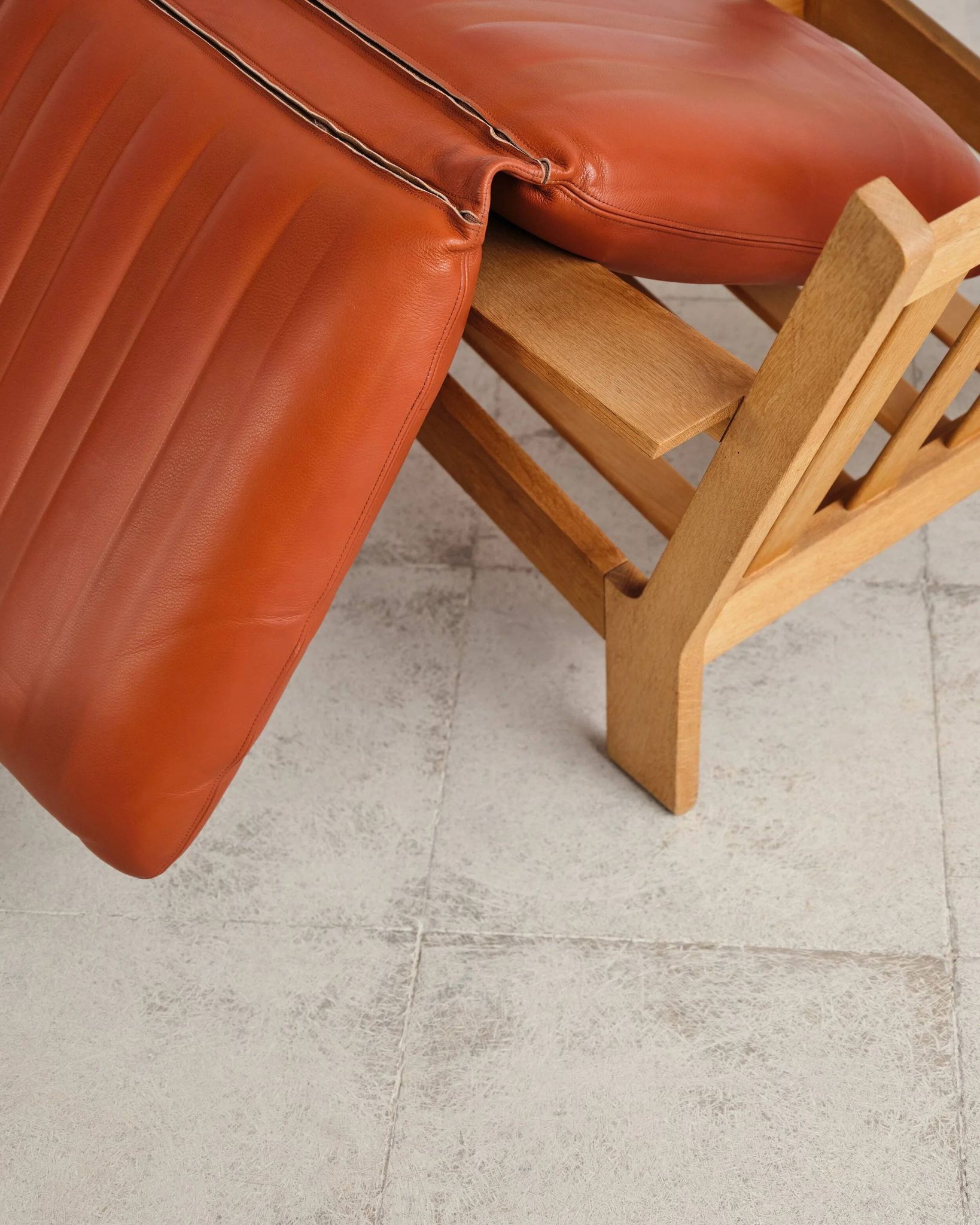Brutalist armchair in oak and leather by Tage Poulsen, Denmark, 1970s.