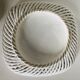 Covered basket in white woven ceramic and fruit slip.