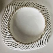 Covered basket in white woven ceramic and fruit slip.