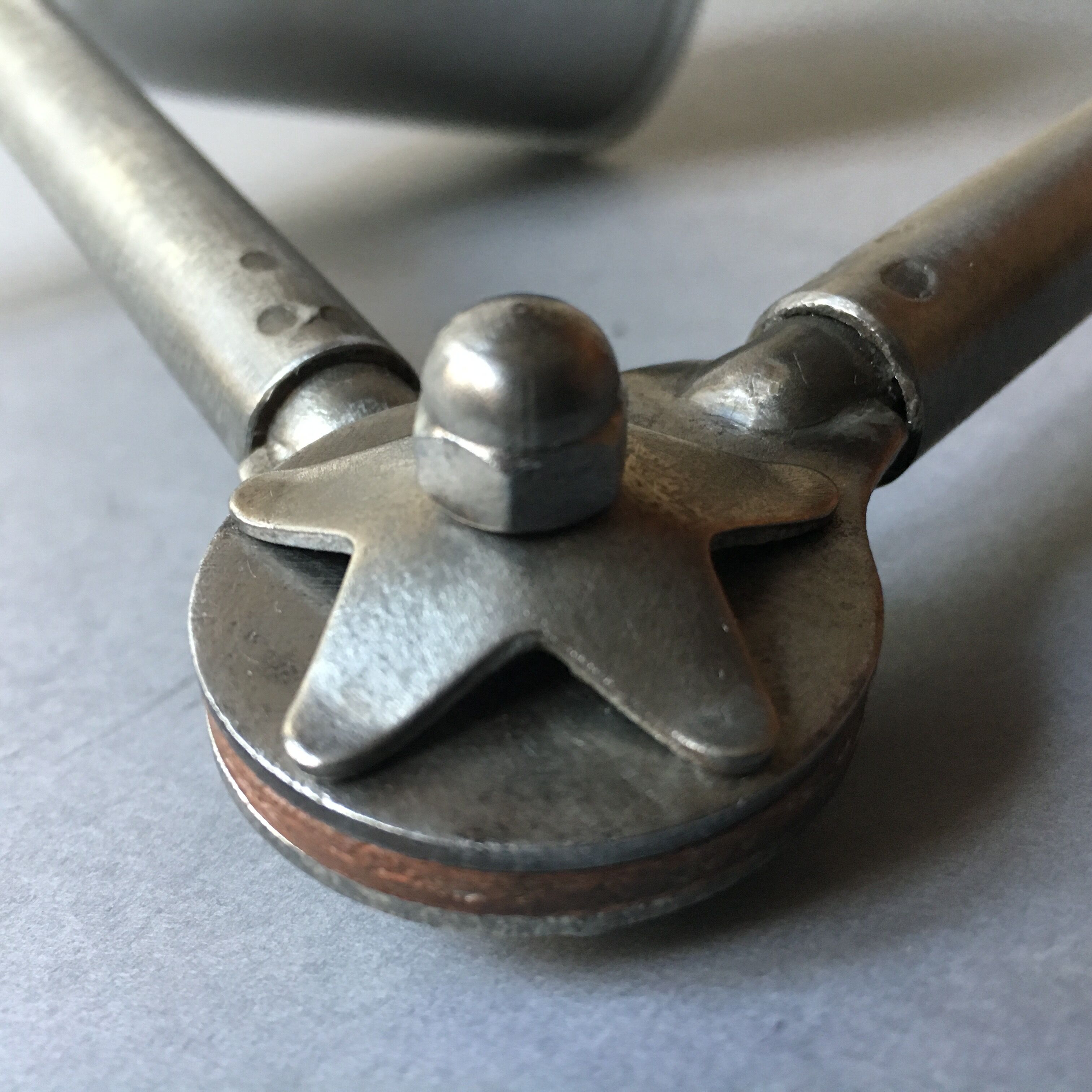 Old industrial lamp has vise 'mazda '.