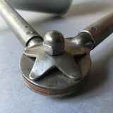 Old industrial lamp has vise 'mazda '.