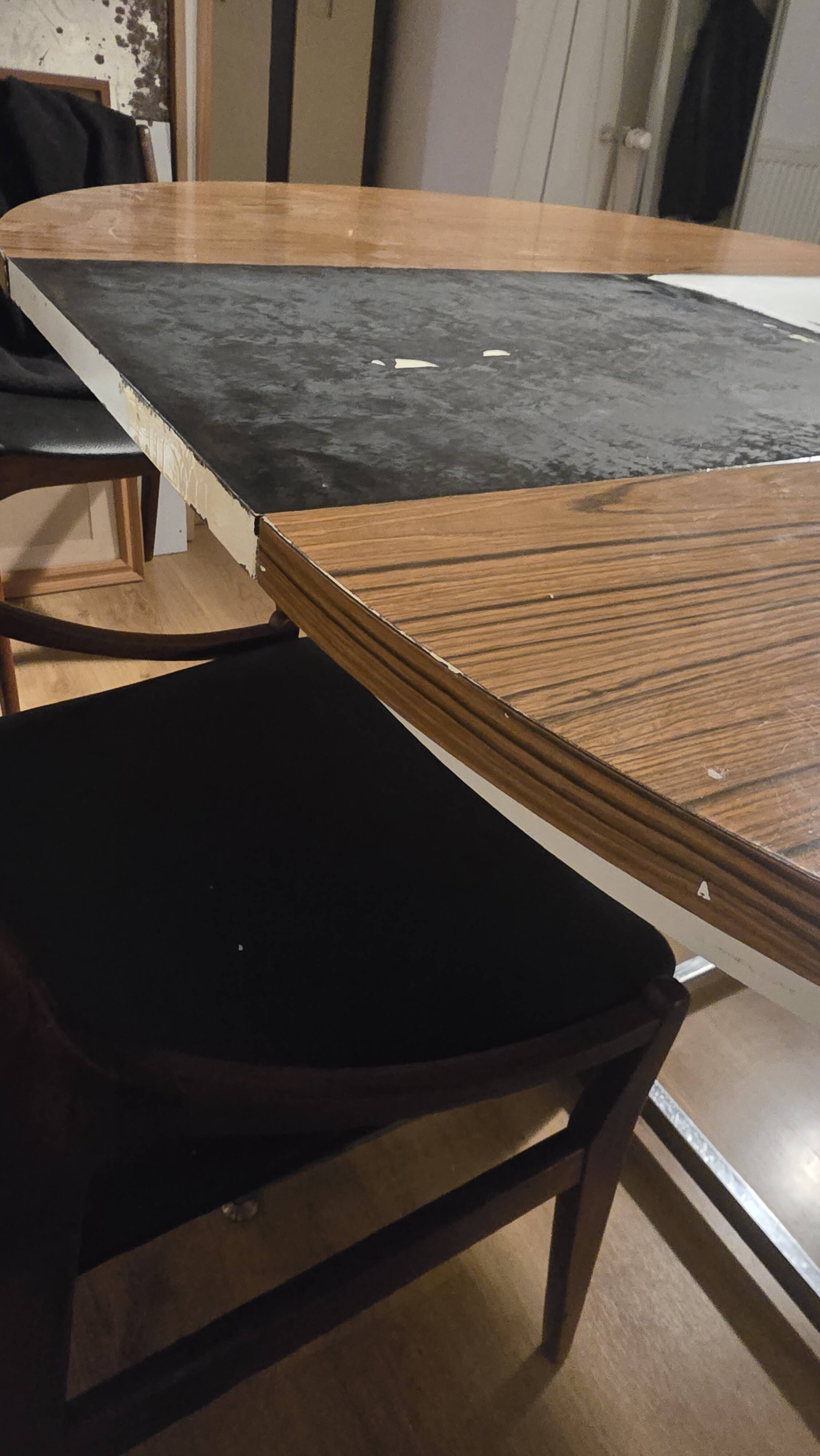 Extendable round table with a space age vintage mid-century formica top.