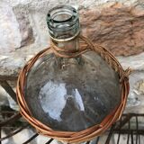 Bottle in clear glass with wicker