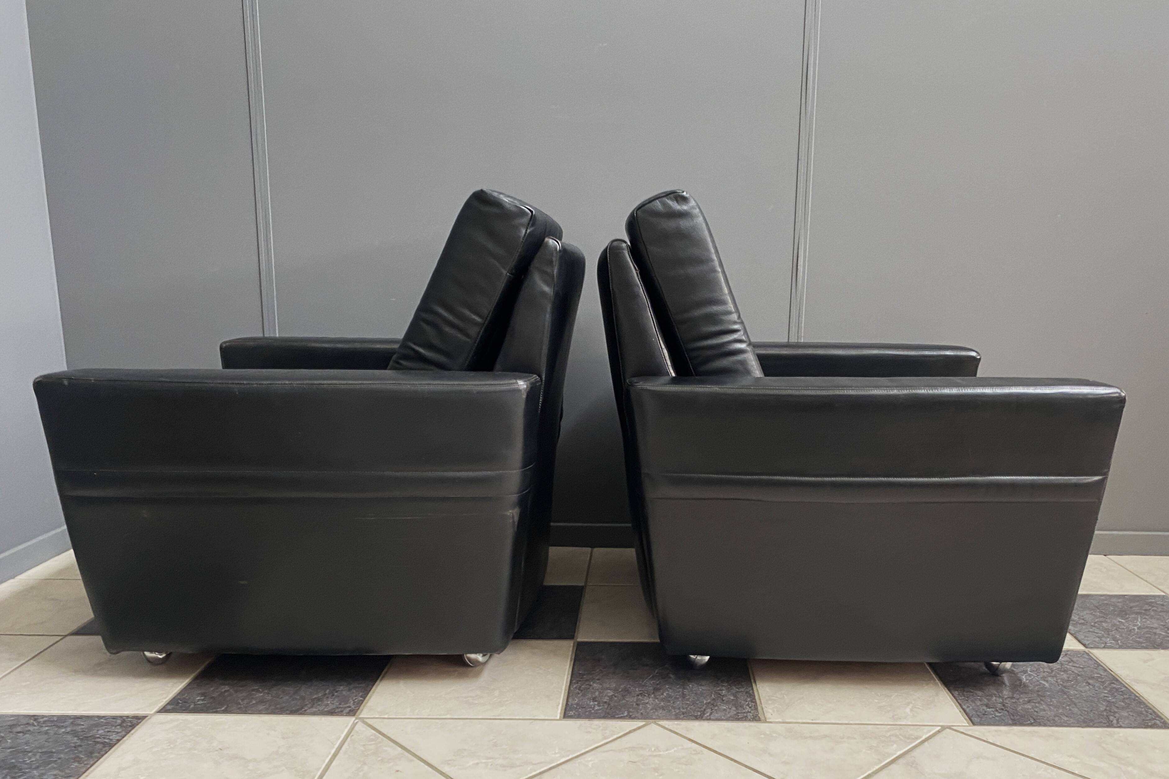 2 Black leather arm chairs 1960s on wheels