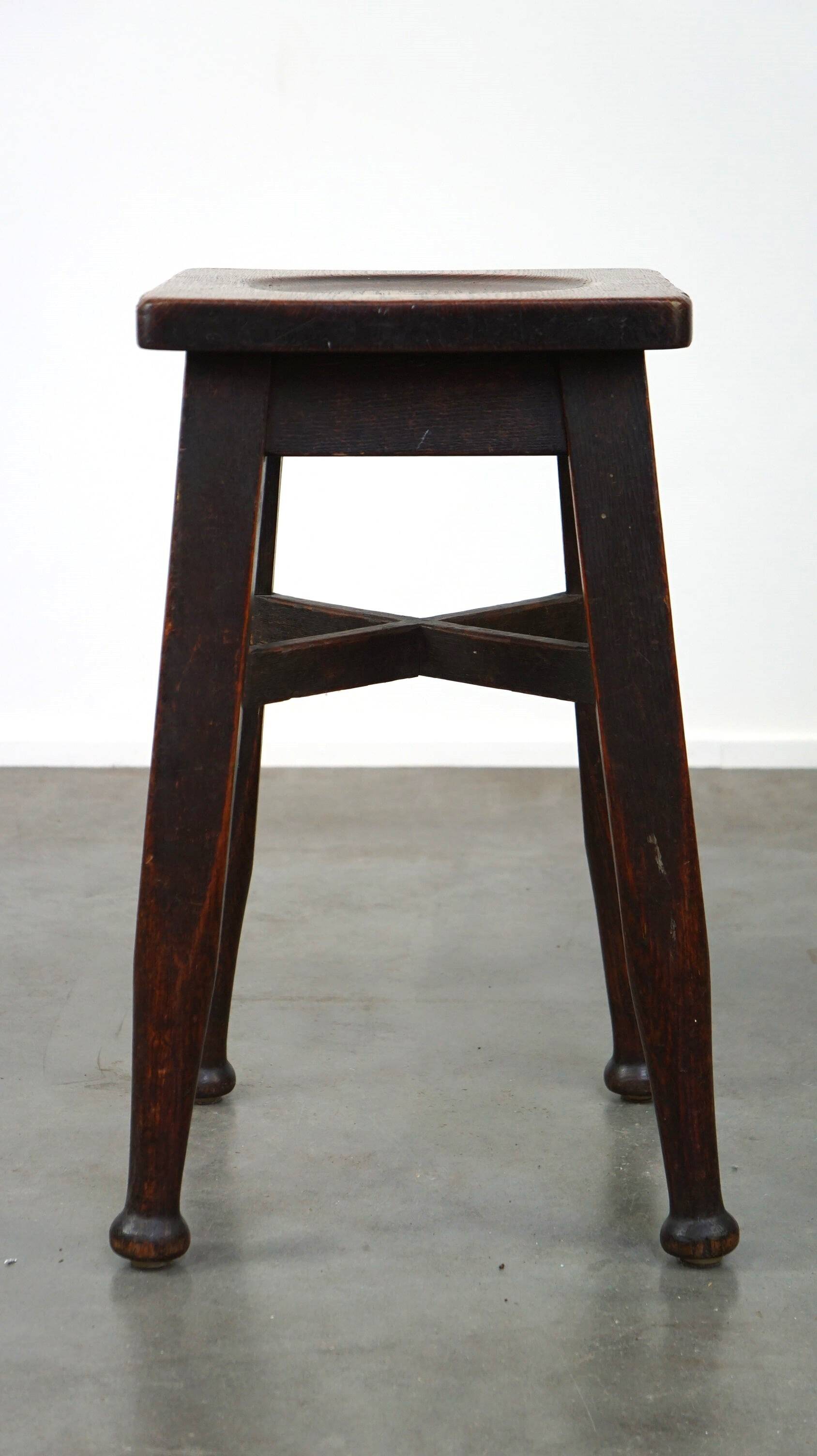 Antique English solid oak stool with a touch of art nouveau style