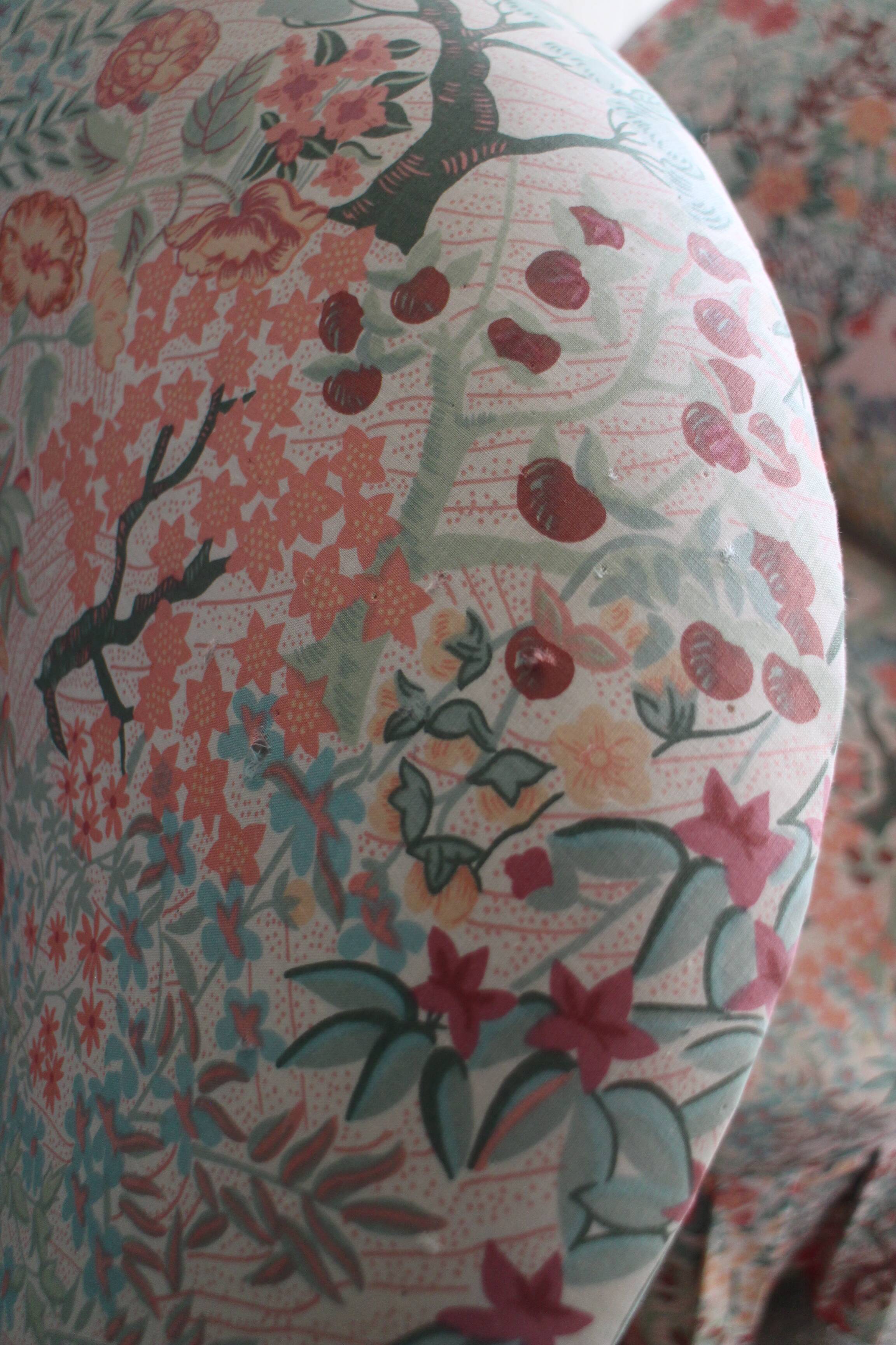 pair of toad armchairs in floral fabric.