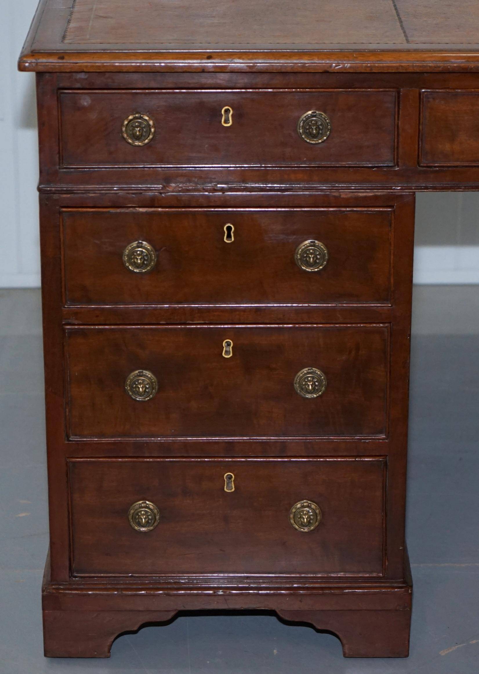 Double-sided partner's desk in walnut, George III, circa 1780, with lion head handles.