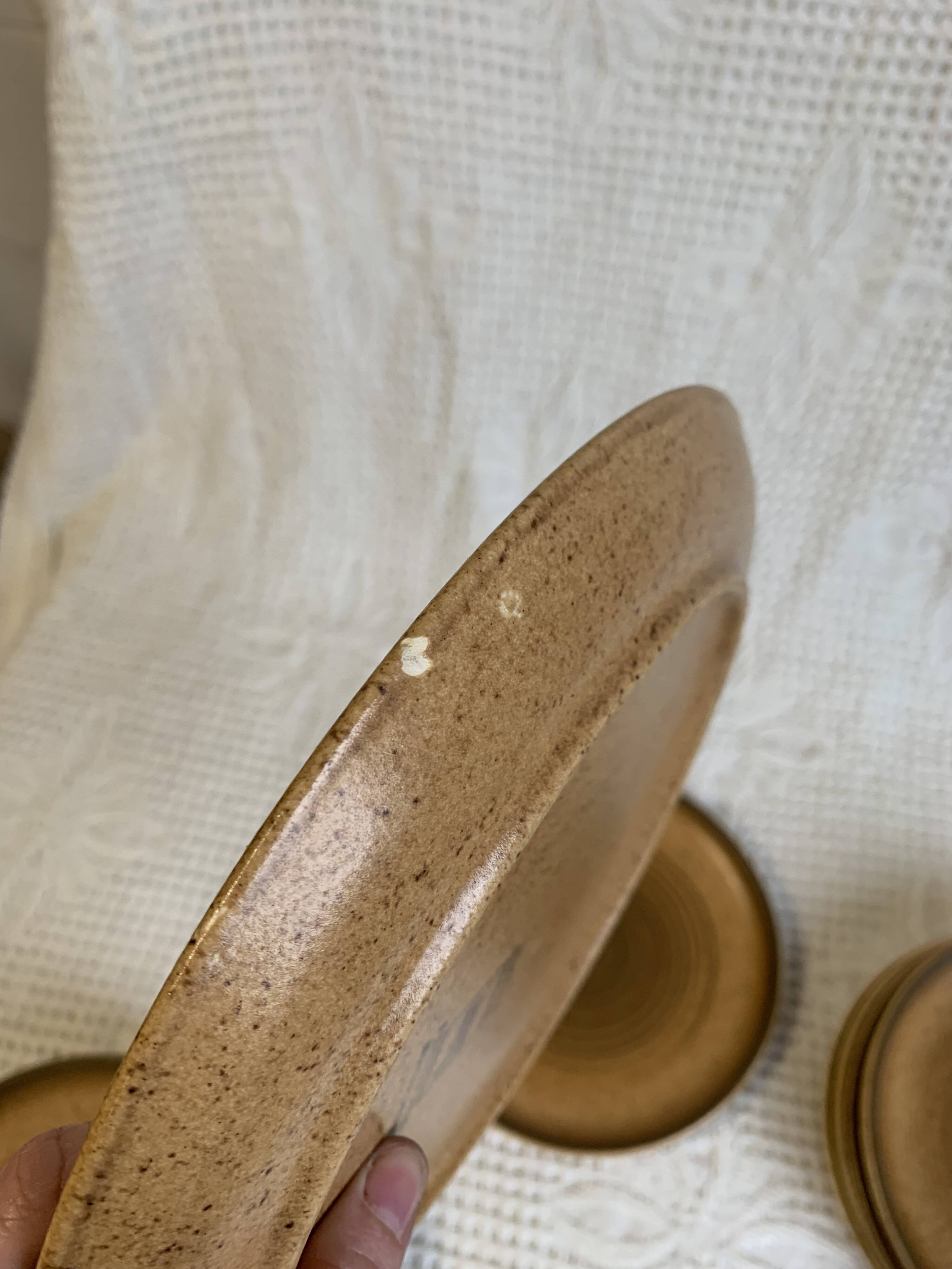 8 Longchamp enamelled stoneware plates, 1970