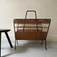 Porte revue en fer forgé noir et rotin dlg Raoul Guys, 1950