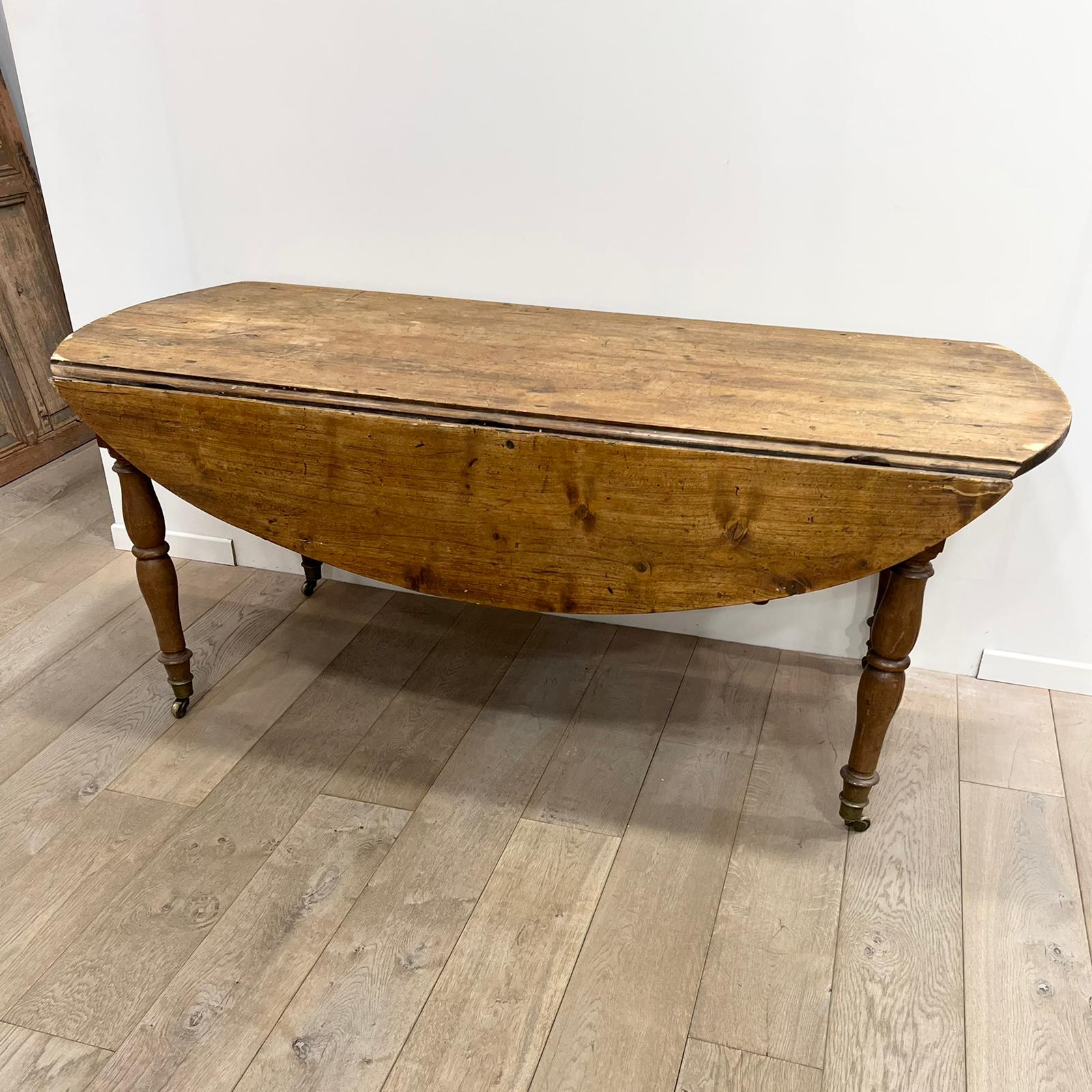 Louis Philippe wood dining table with shutters and casters