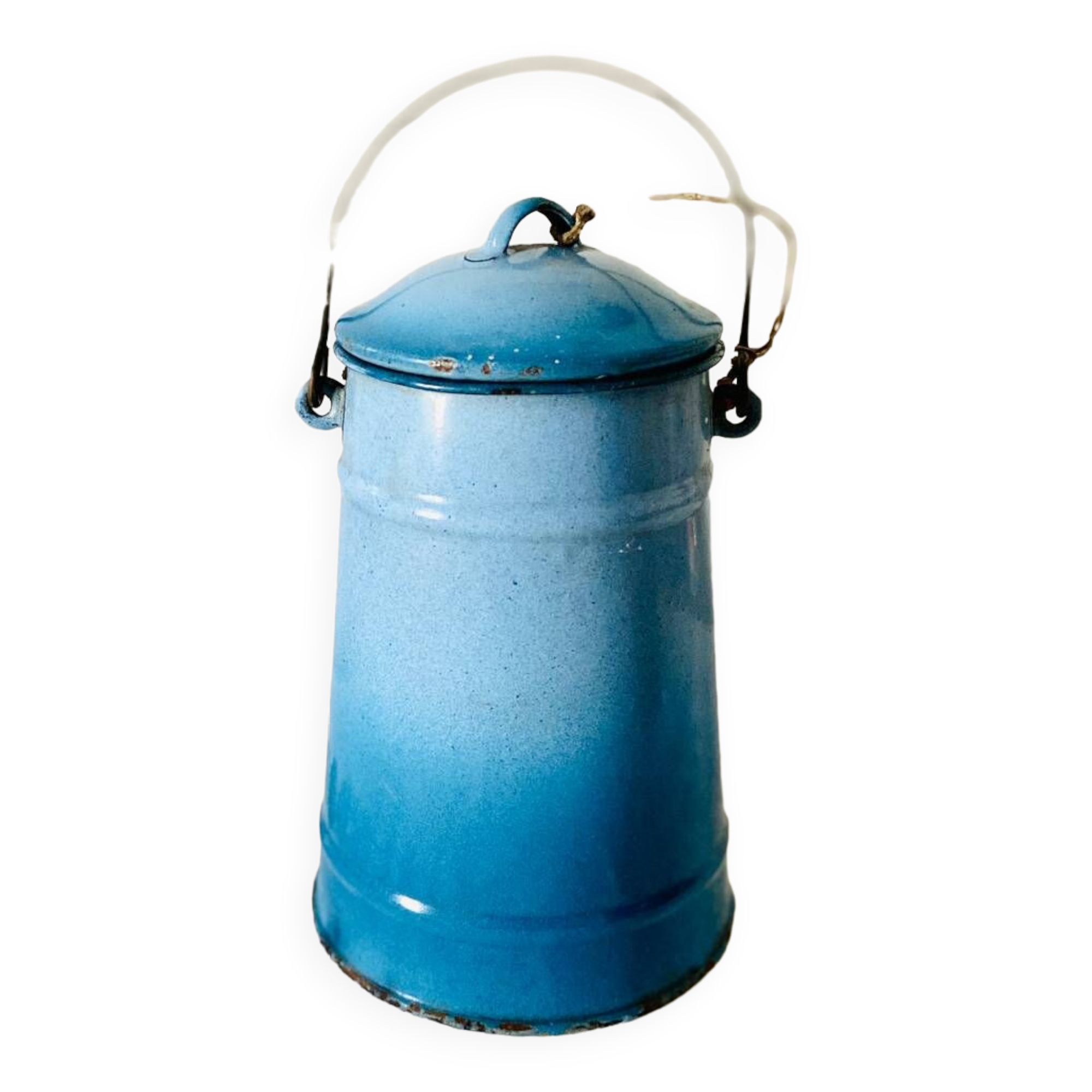 Old vintage milk jug in degraded blue enameled sheet metal