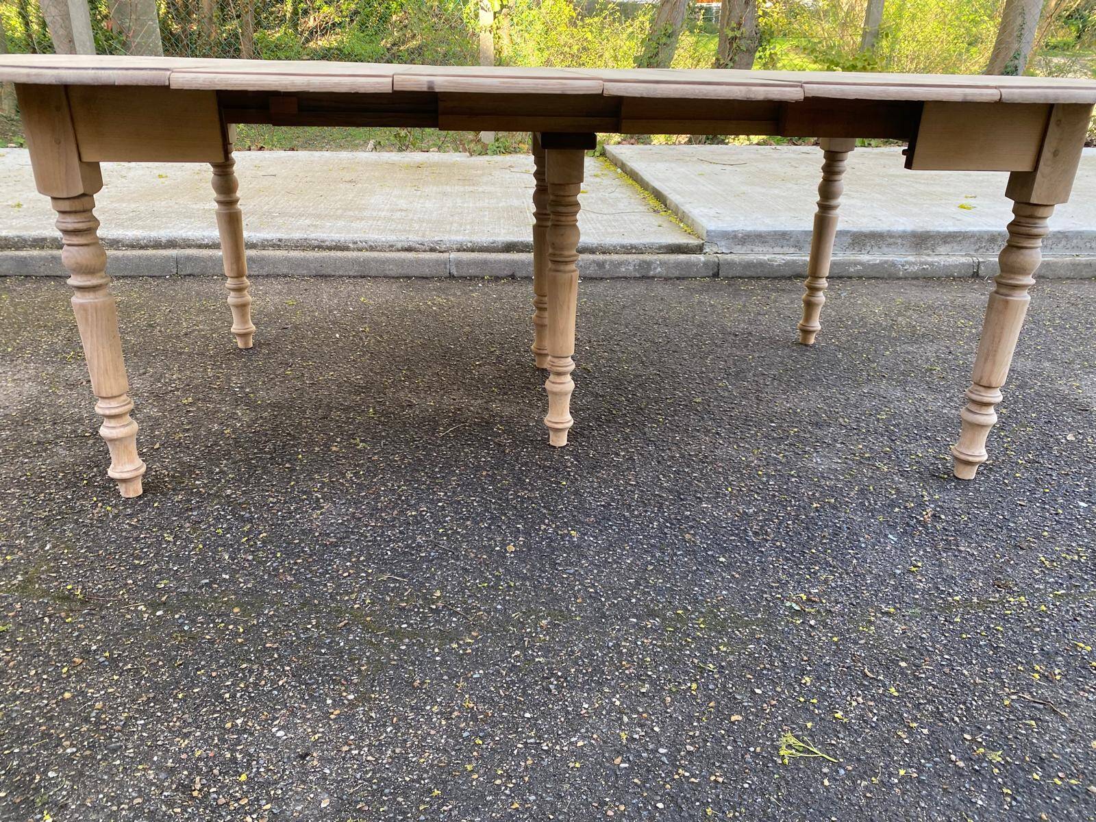 Renovated Louis Philippe round extendable dining table with 4 leaves.