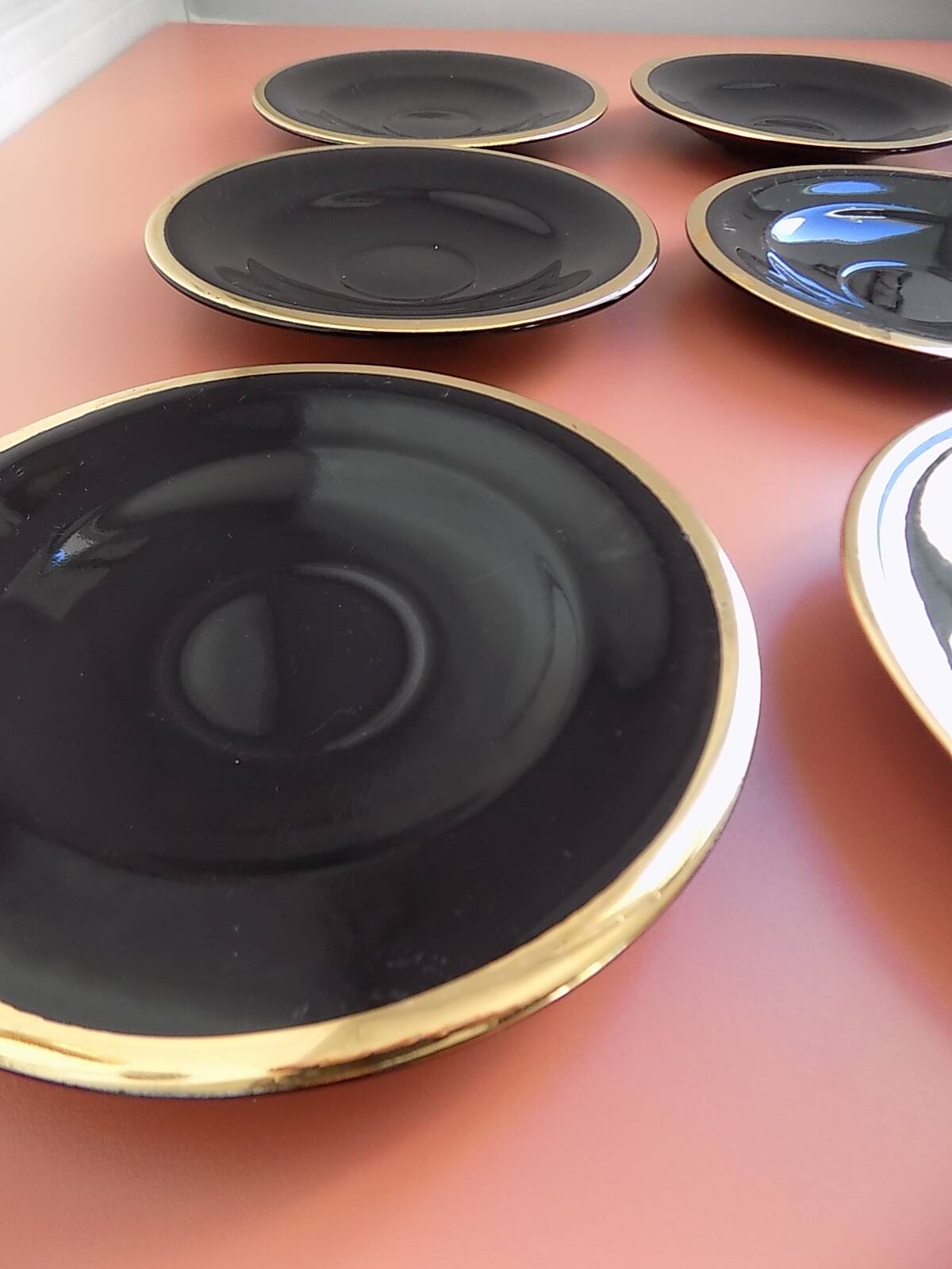 set of 9 black and gold Salins cups and saucers