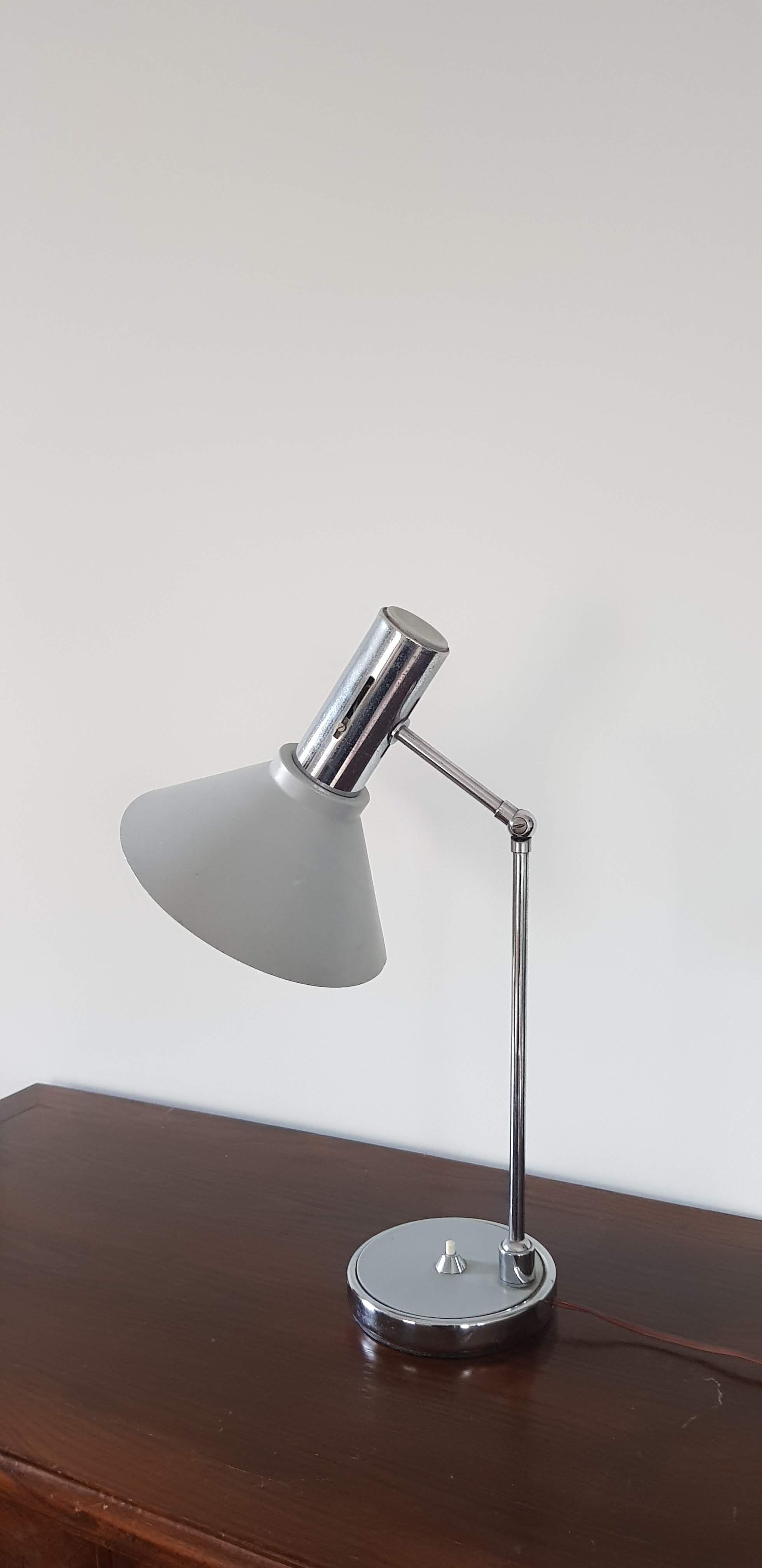 Chrome metal desk lamp and gray articulated arm
