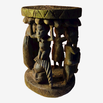 African wooden stool carved in the shapes of characters