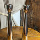 Pair of polished aluminium candlesticks