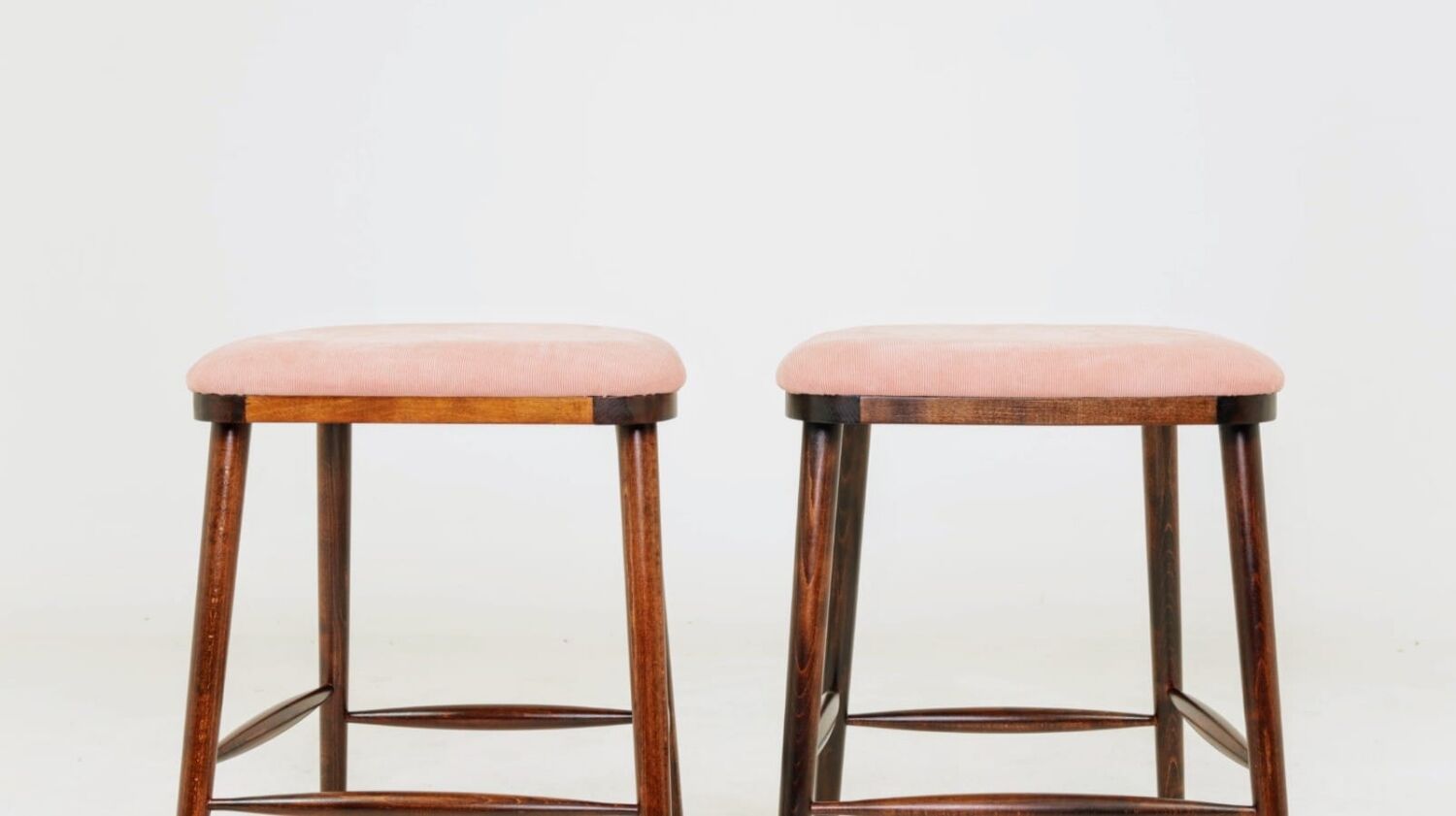 Bar stools matching the vintage style, in pink corduroy.
