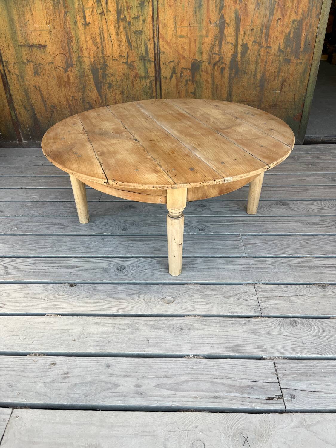 Round coffee table in raw wood