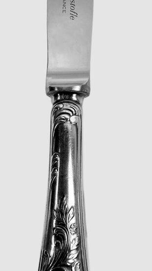 Twelve Christofle Marly table knives, silver-plated metal handles.