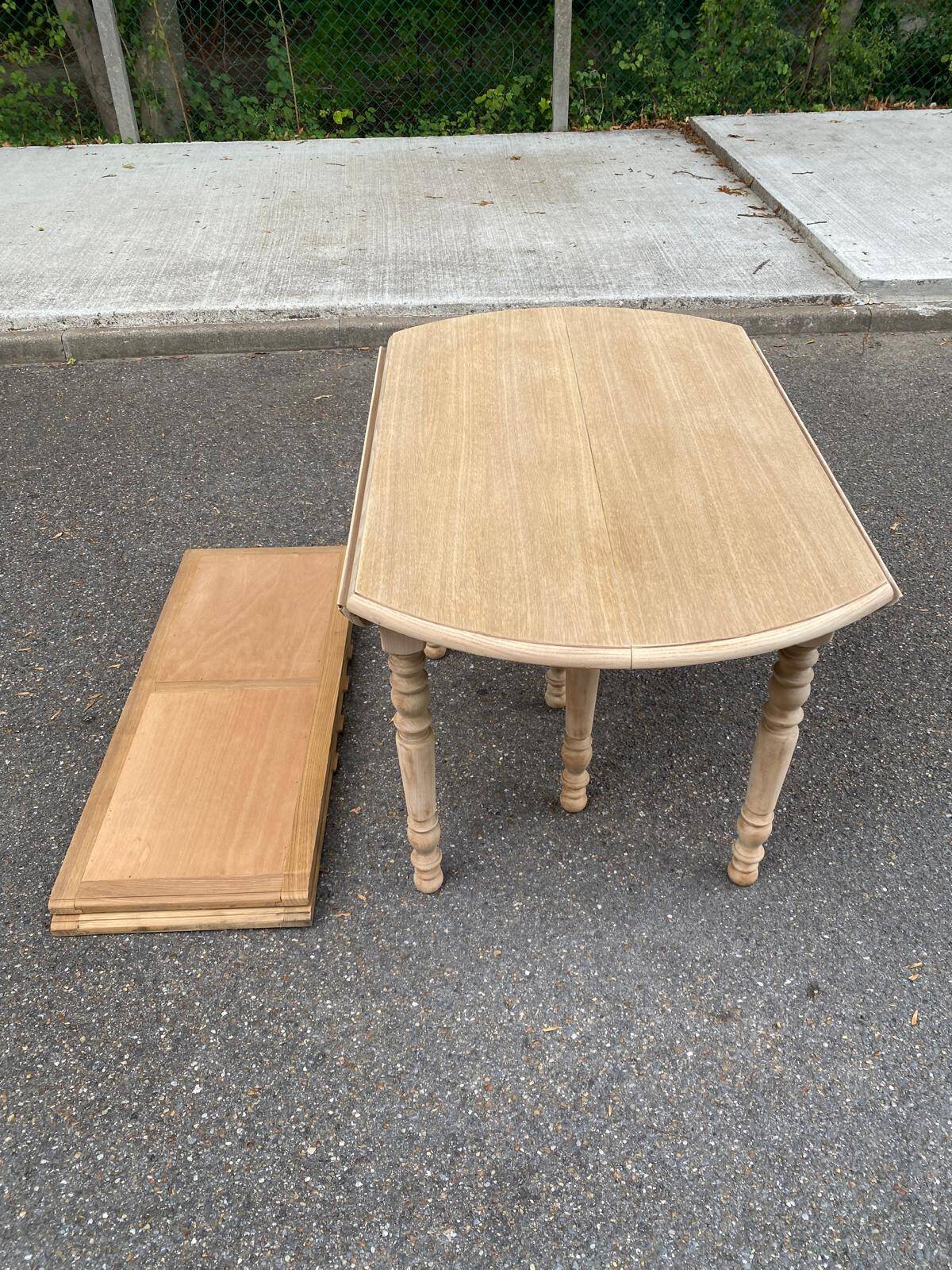 Round dining table with extendable leaves, Louis Philippe style, stripped in raw oak.