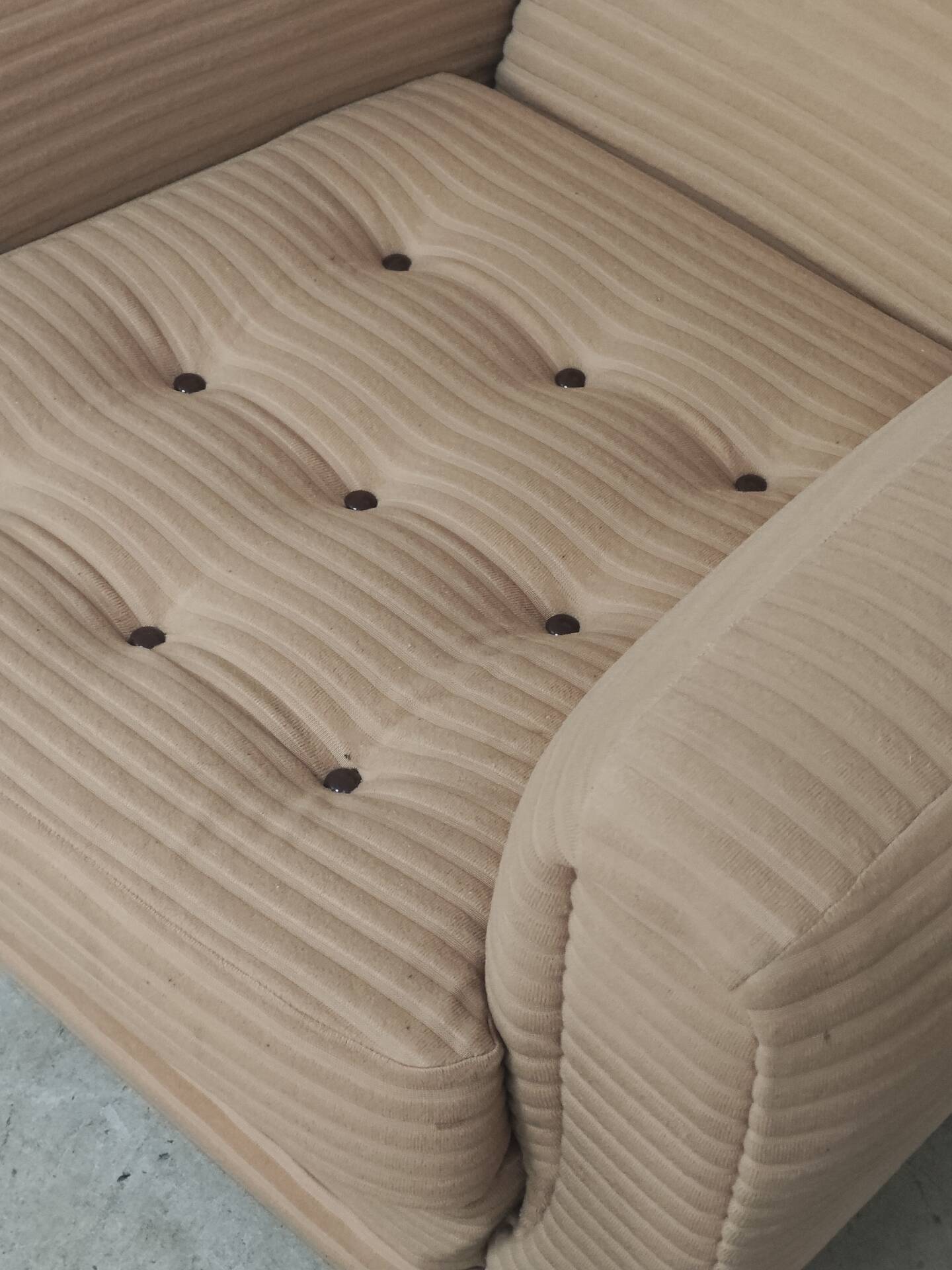 Beige wingback armchair and TVAR footrest, former Czechoslovakia.