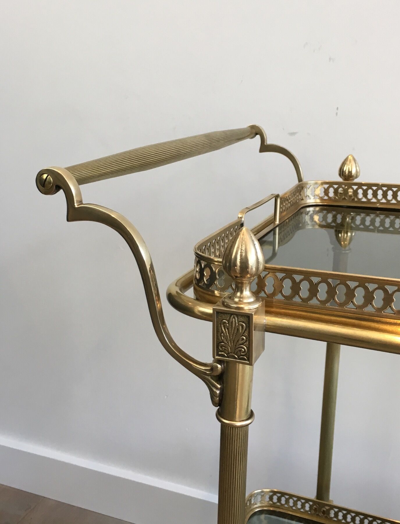 Neoclassical style rolling table in brass with blue glass tops