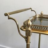 Neoclassical style rolling table in brass with blue glass tops