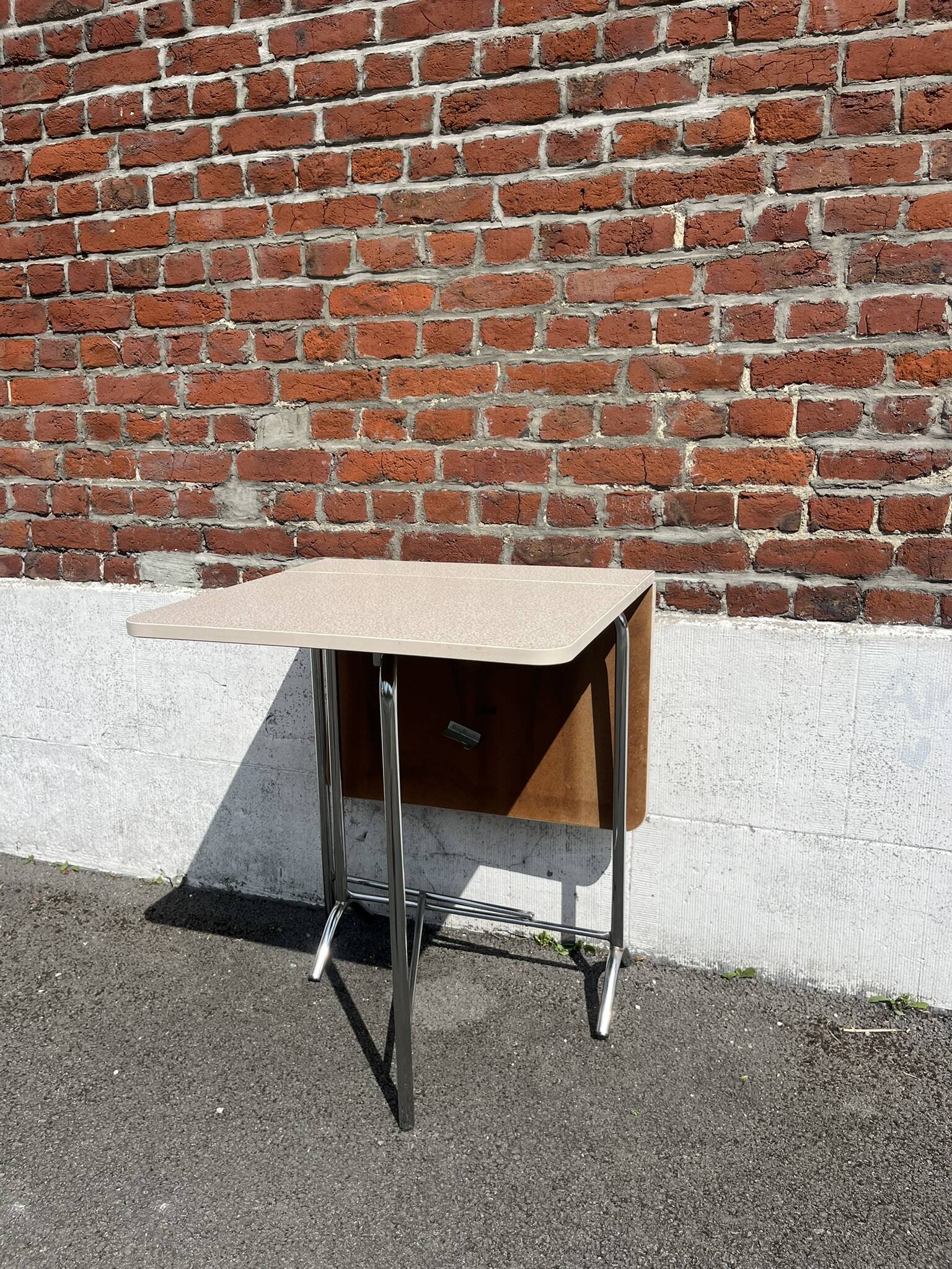 Folding table with chrome and pink formica.