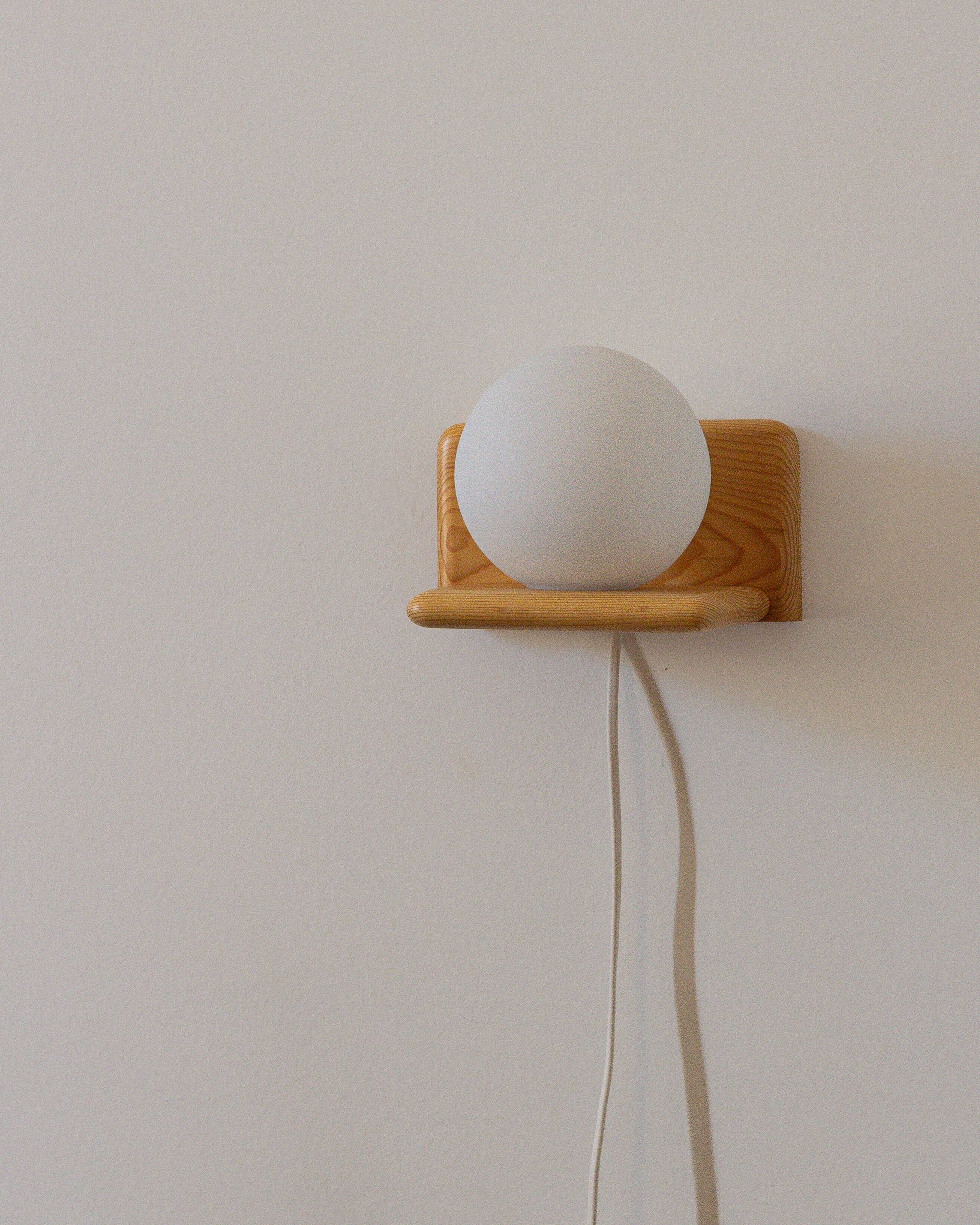 Duo of pine and opaline glass wall lights, 1980s