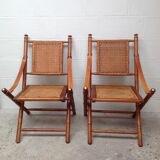 Pair of folding chairs in bamboo and caning, leather and brass