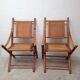 Pair of folding chairs in bamboo and caning, leather and brass