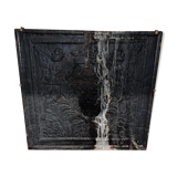 huge old fireplace plate has decoration of angels, crown and fleurs-de-lis