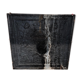 huge old fireplace plate has decoration of angels, crown and fleurs-de-lis
