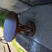 Art Deco side table in brown walnut, round top and scroll legs, France 1930s.
