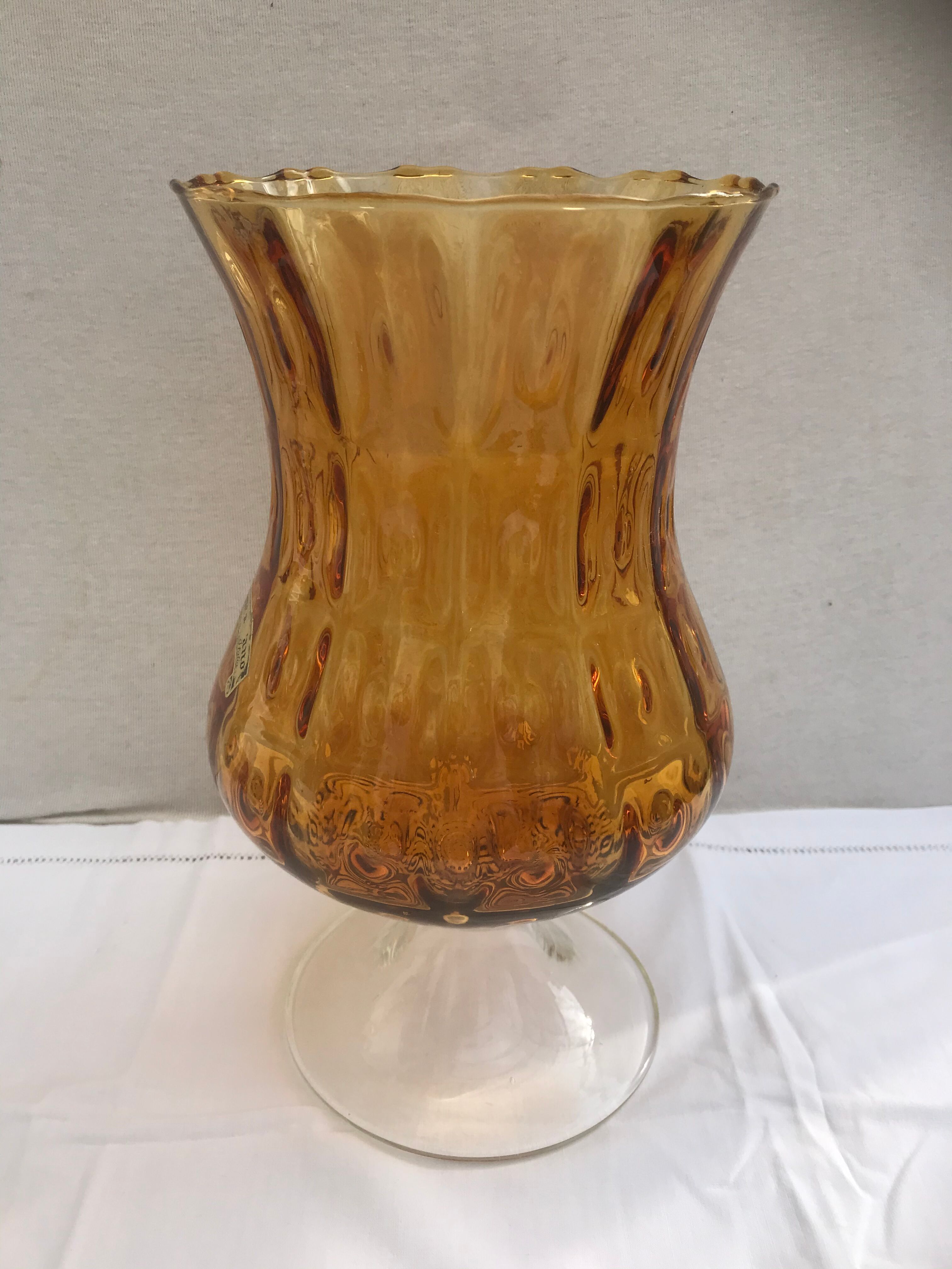 Ancient vase on foot orange glass