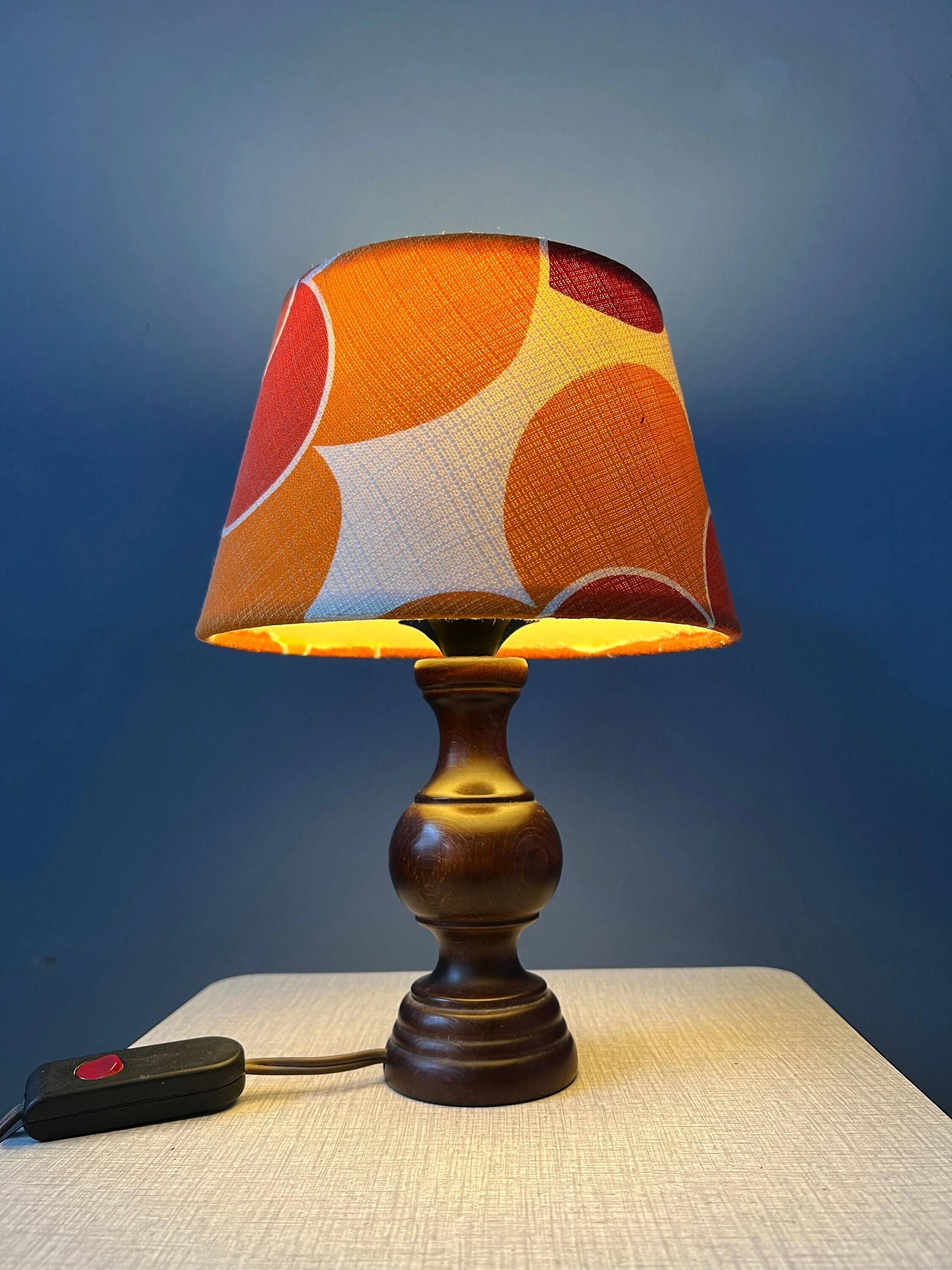 Vintage Space Age table lamp with orange fabric shade.