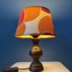 Vintage Space Age table lamp with orange fabric shade.