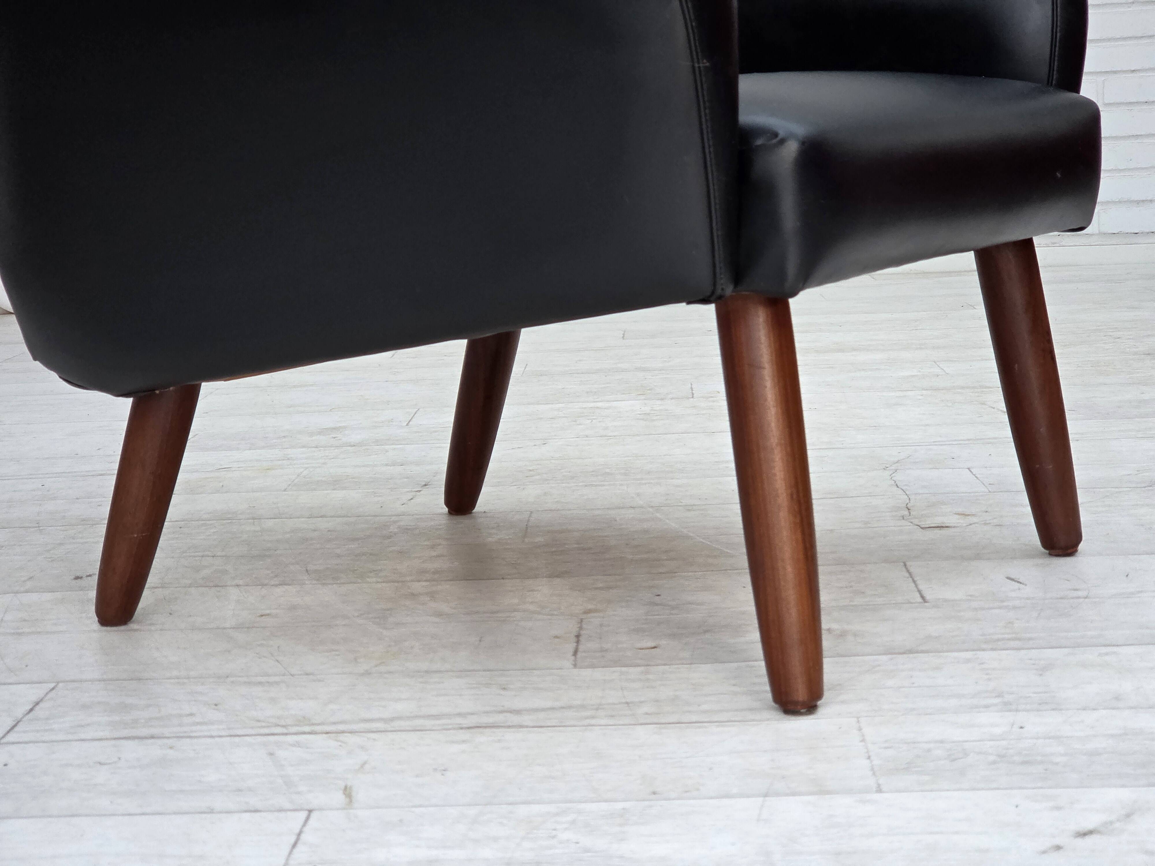 1970s, Danish highback armchair, black artificial leather, teak wood legs.