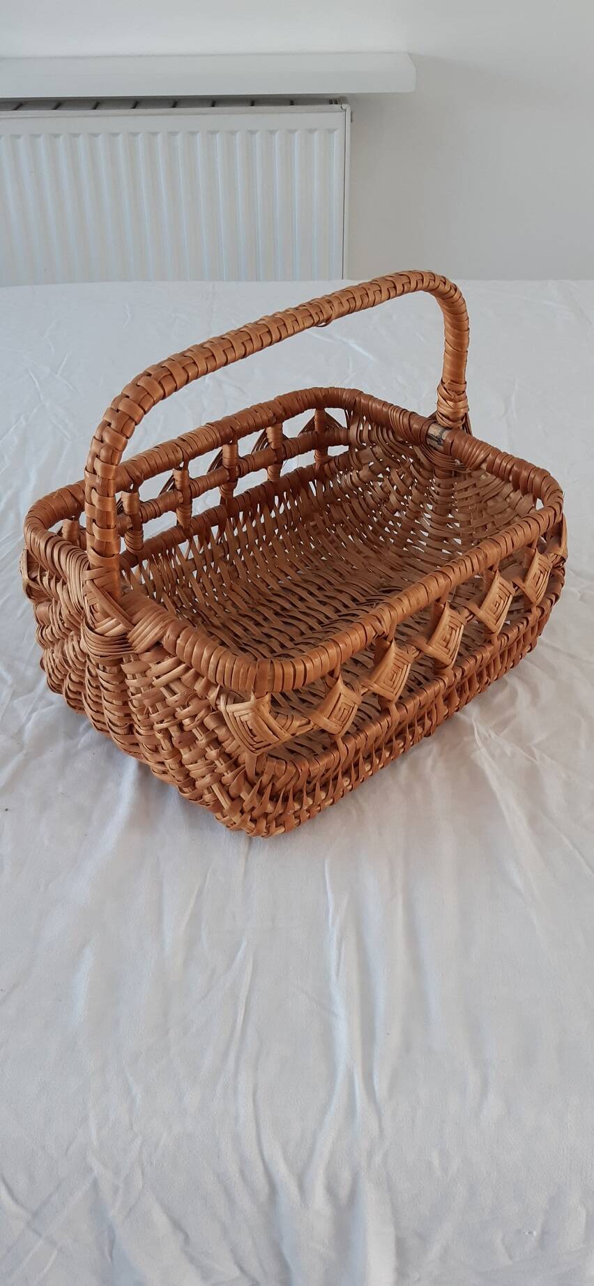 Old wicker basket with diamond-shaped decorations