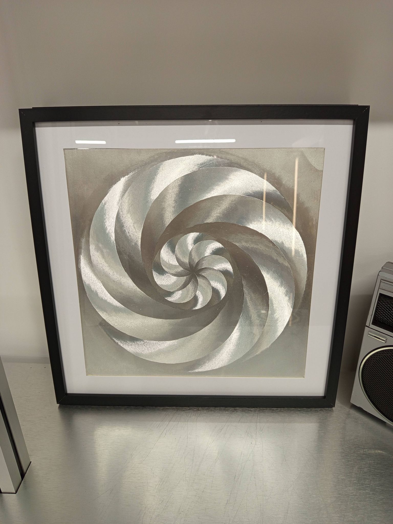 a Kinetic Op Art Aluchromy under glass frame.