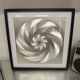 a Kinetic Op Art Aluchromy under glass frame.