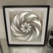 a Kinetic Op Art Aluchromy under glass frame.